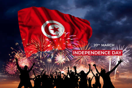 Evening sky with majestic fireworks and flag of Tunisia on National holidayの写真素材