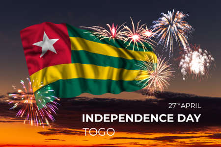 Evening sky with majestic fireworks and flag of Togo on National holidayの写真素材