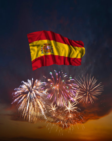 Holiday fireworks in evening sky and flag of Spain for National Independence dayの写真素材