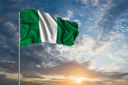 Waving National flag of Nigeria in beautiful skyの写真素材
