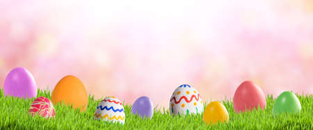Easter background for your design with colorful eggs in green grassの写真素材