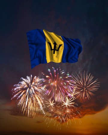 Holiday fireworks in evening sky and flag of Barbados for National Independence dayの写真素材