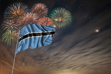Waving National flag of Botswana and holiday fireworks on night sky background with stars for independence dayの写真素材
