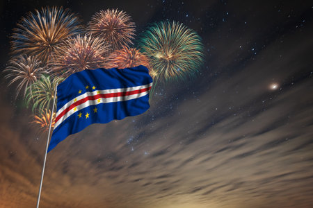Waving National flag of Cape Verde and holiday fireworks on night sky background with stars for...