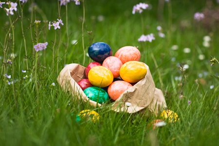 Paper bag full of Easter eggs in grass