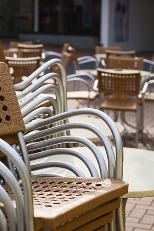 Stacks of outdoor chairs and tablesの写真素材