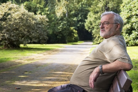Senior man relax on a bench in parkの写真素材
