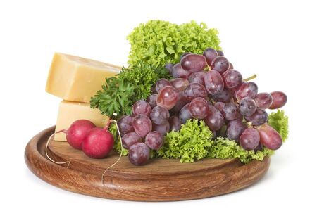 Red grape and cheese on carving boardの写真素材