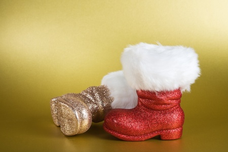Pair of Santa boots on gold backgroundの写真素材