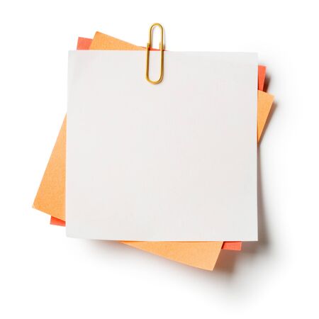 White, orange and red note papers with paperclip on white backgroundの写真素材