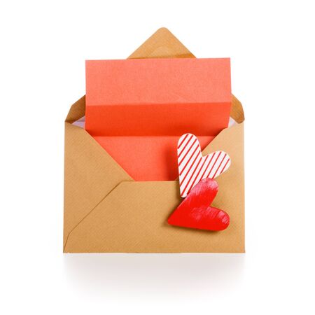 Envelope with red notepad and two hearts on white