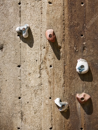 Closeup of wooden climbing wall with five holdsの写真素材