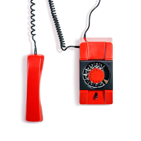 Vintage red telephone. Wall phone isolated on white background. Communication technology. Object with clipping pathの写真素材