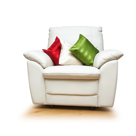 White armchair with colorful pillows isolated on white backgroundの写真素材