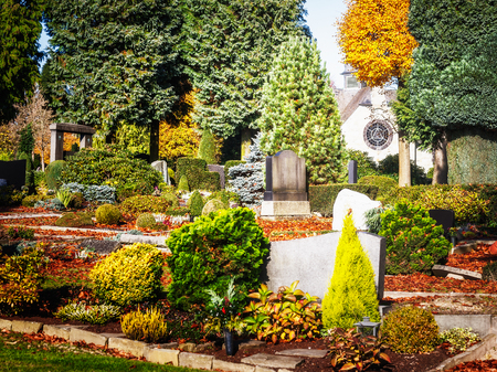 Old german cemetery with white chapel. Autumn sunny day