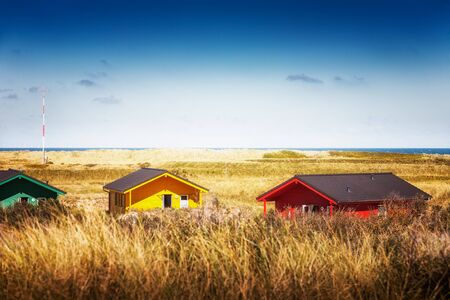 Colorful beach houses in dune grass at the beach of Helgoland, North sea, Germany. Travel destinations. Selective focusの写真素材