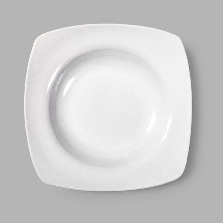 Empty white plate on grey background. Soup dish. Modern kitchen. Single objectの写真素材