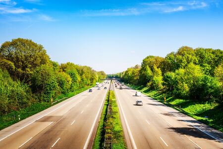 Highway traffic with cars and trucks on sunny spring day, Germany