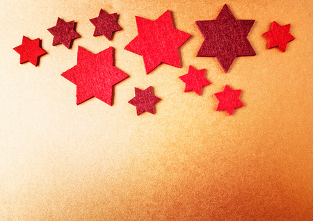Christmas background. Red stars on golden paper. Top view, flat layの写真素材
