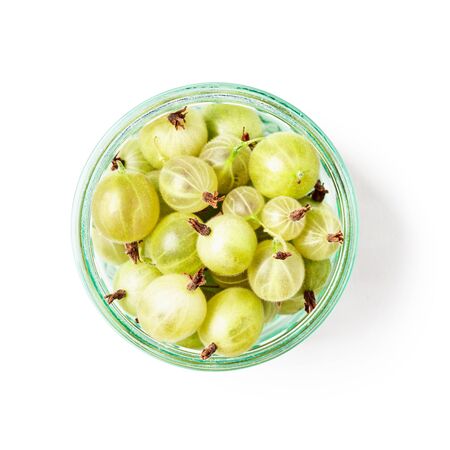 Fresh gooseberry fruits berries in transparent glass bowl. Healthy eating concept. Single object isolated on white background clipping path included. Top view, flat lay, design elementの写真素材