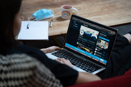 Someone looking at her open laptop computerのeditorial素材