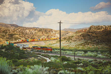 Colorful cargo train travelling through desert of Nevadaの写真素材