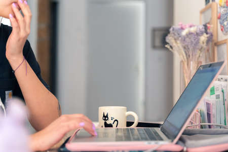 Young woman working on computer in her home office.