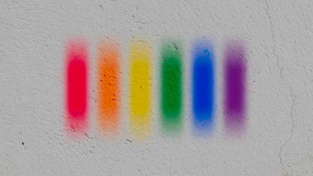 rainbow colors painted on the wall - pride is on the streets - gay pride flag
