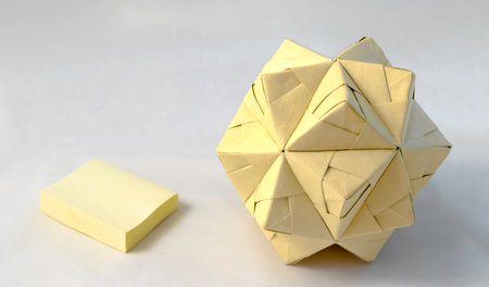 origami polyhedron made with sticky notes on bright backgroundの写真素材