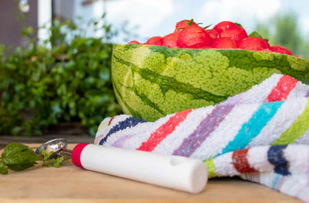 sweet and juicy watermelon small balls and mint salad, served using the skin as a bowl. Summer food concept. Selective focus. Close upの写真素材