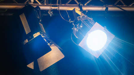 close up of two spotlights shining. Teal and orange illumination.