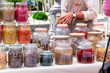 clerk serving a customer at a spice stall at a street marketの写真素材