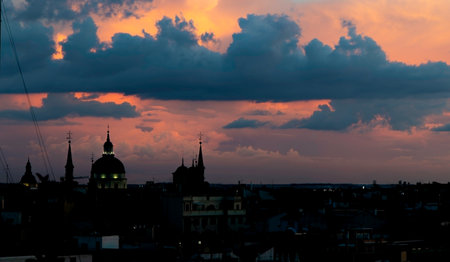 Skyline of Madrid, Spain, at nightfall. Old town district. Cloudy warm sky.の写真素材