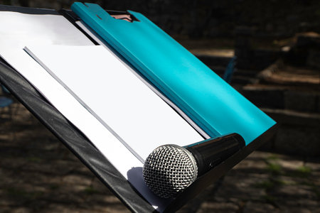Microphone on a podium lectern with blank papers. Conference concept. Select focus. Mockup.の写真素材