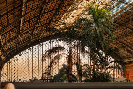 Indoor gardens and stained glass wall of Atocha railway Station in Madrid, Spain