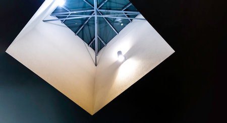 Square skylight illuminated by wall lights. Modern architectural detail. Copy spaceの写真素材