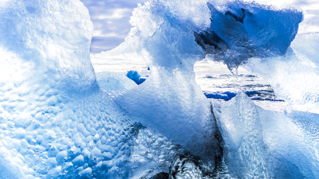 Large ice formation on the coast. Through its irregularities you can see the ocean. The ice shines...
