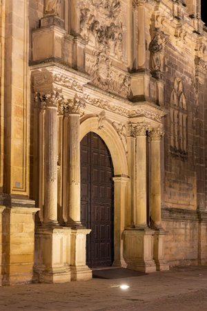 Gate of the Basilica and Royal Collegiate Church of Santa Maria la Mayor de los Reales Alcazares of Ubeda by night. The archway is lit upの写真素材