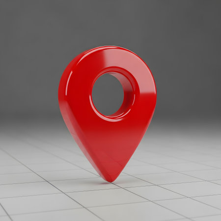 A shiny, three-dimensional red map marker or pin icon is centered on a light gray, subtly textured surface with faint grid lines.の素材