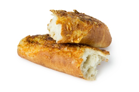 Broken baguette with cheese and garlic isolated on white backgroundの写真素材