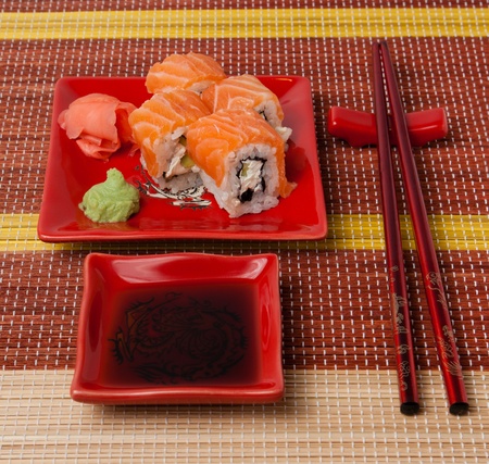 Portion of rolls with soy sauce, ginger, wasabiの写真素材