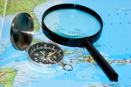 Magnetic Ñompass and magnifying glass on map