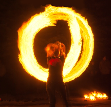 Girl with poi performs fire circle. Fireshowの写真素材