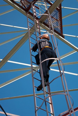 A man walks up the stairs to the tower of communication