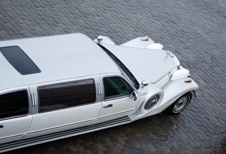 Part of Limousin Excalibur Phantom in outdoor. White car for wedding ceremony on quay at the river of Moscow. In rainy weatherの写真素材
