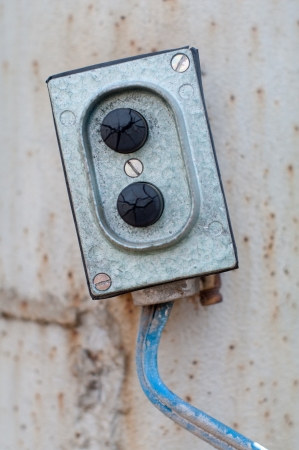old breaker on rusty wallの写真素材