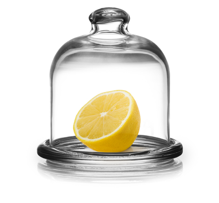 Lemon in saucer with lid isolated on white backgroundの写真素材