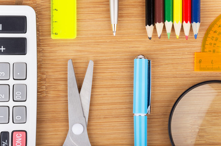 Various office supplies on wooden table surface