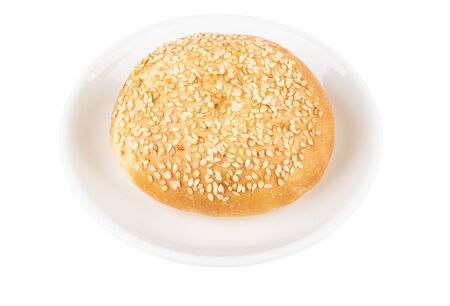 Appetizing bun with sesame seeds on glass saucer isolated on white background
