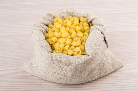 Pasta in bag of coarse cloth on table